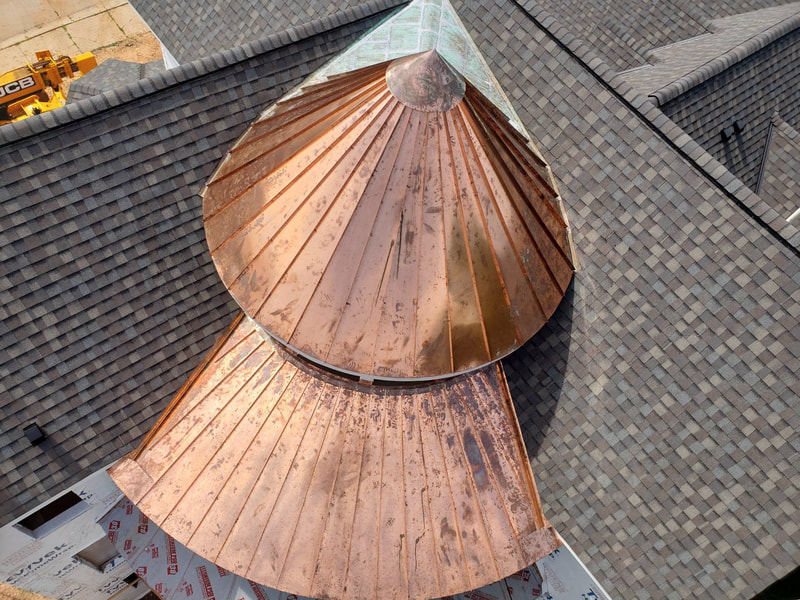 Aerial view of a circular custom copper roof. 