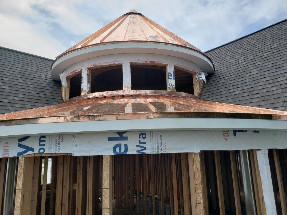 Front view of custom circle  copper roof and asphalt shingles. 