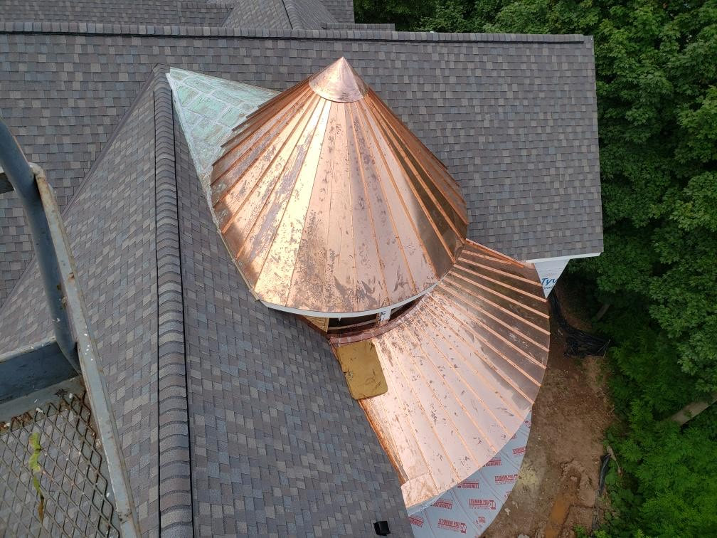 Overhead view of custom circle copper and asphalt shingle roof. 