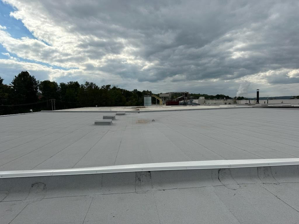 gray modified bitumen commercial roof system on the CertainTeed plant in L'Anse Michigan | Paul Crandall and Associates, Inc.